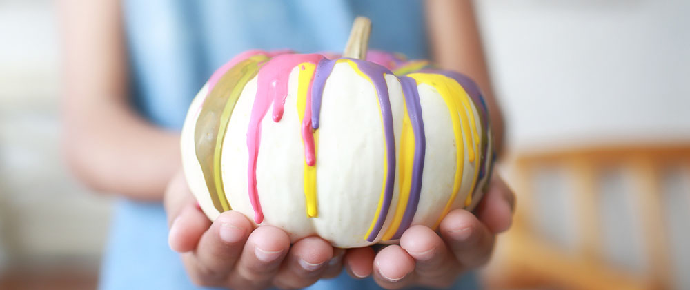 paint poured on white pumpkin craft